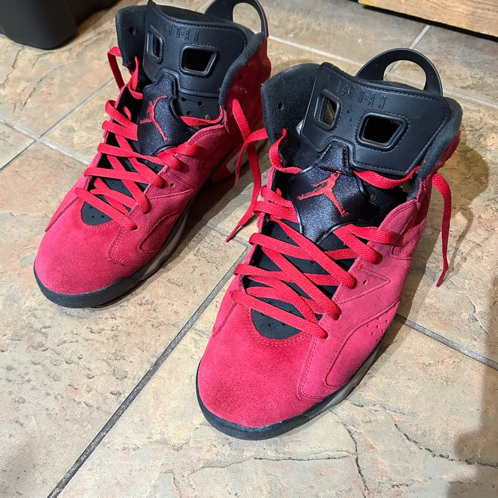 Red and black Jordan 6s , lightly worn . Size 12